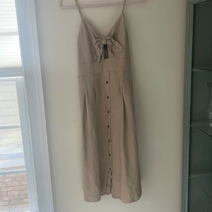 Tan dress, tie closure on top, elastic back with pockets
